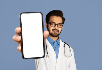 Indian Male Doctor Demonstrating Blank Smartphone Screen, Advertising Medical App