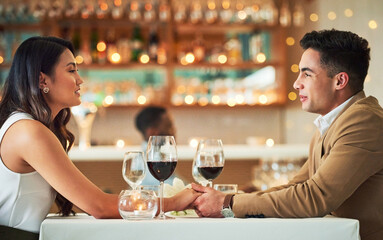 Couple holding hands, romantic date in restaurant, celebrate Valentines day holiday with love and fine dining together. Commitment, interracial relationship and man with woman, trust and support