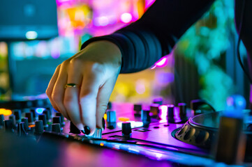 DJ Hands creating and regulating music on dj console mixer in concert nightclub stage