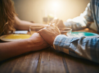 Love, couple and holding hands at restaurant on table, for care and bonding together. Valentines day, romance and affection, passion of man and woman on romantic date enjoying quality time in cafe.