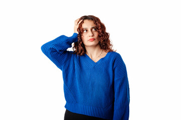 Portrait of woman wearing knitted sweater standing isolated over white background holding the palm hand on her head is experiencing a problem and looks to the empty copy space for a solution.