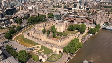 Sweeping Drone shot of Tower of London over the River Thames in Summer