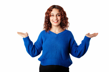 Cheerful woman wearing blue pullover sweater isolated over white background arms at sides, laughing and looking at the camera. Spreading arms to sides. Empty places in two side with palms.