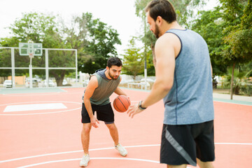 Friends working out playing sports on the basketball court