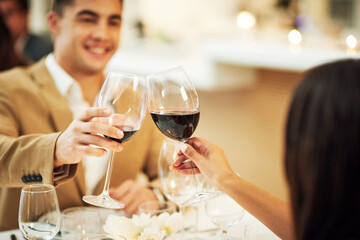 Toast, wine and couple in restaurant for celebration, romantic dinner and anniversary together. Relationship, fine dining and man and woman cheers with drinks, alcohol and relax at hotel on honeymoon