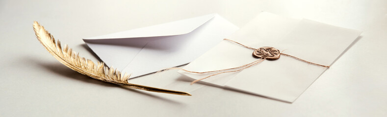 Golden pen and stamped envelope