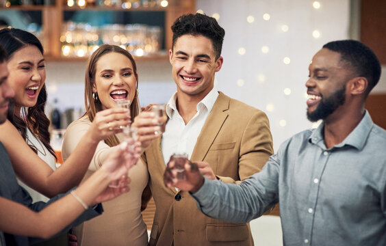 Group of friends, cheers and shots in celebration at restaurant party and happiness together for valentines day. Love, friendship and toast, happy hour social event, people smile at pub drinks date.