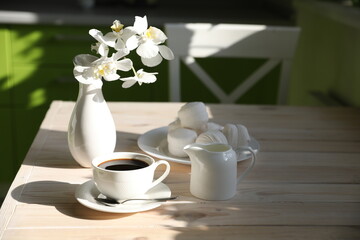 breakfast with black coffee, milk and marshmallow on white background