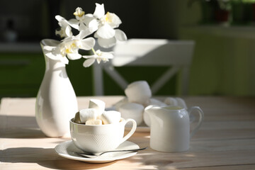 breakfast with black coffee, milk and marshmallow on white background