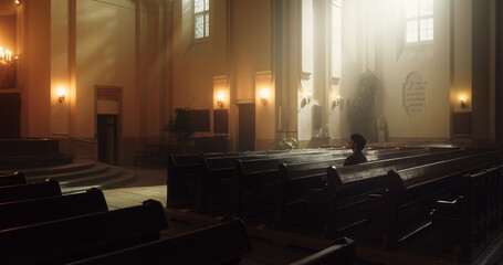 Solemn Christian Person Sitting Piously in a Grand Old Church. Thinking about Earhly Life, Morality, Ethnics but Seeking Divine Guidance through Faith. Atmosphere of Peaceful Kindness for Eternal Soul