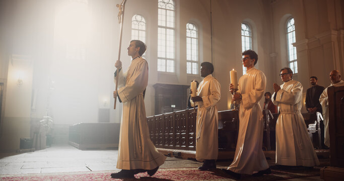 Liturgy in Grand Church: Majestic Procession Of Ministers And Priests Walking with Processional Cross. Congregation Stands In Reverence, Christians Rejoice In Ceremony of Mass