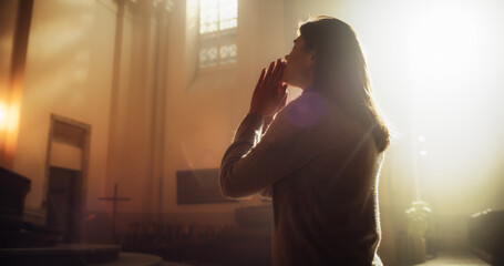 Side View: Christian Woman Getting on her Knees in Front of Altar and Starting to Pray in Church....