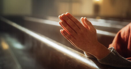 Christian Person Praying with Hands Folded In Reverence. Expression Humility and Faith in God, Seeking Guidance and Strength. Following the Teaching of Lord Jesus Christ, the Bible. Cinematic Concept
