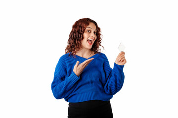Cheerful woman wearing blue pullover sweater isolated over white background holding credit card,...