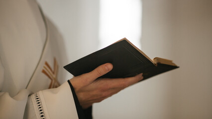 In Christian Church: Close Up of The Bible, Gospel of Jesus. Minister Leads The Congregation In Prayer and Reads From The Holy Book, Priest Providing Guidance, Belief, Hope to People.