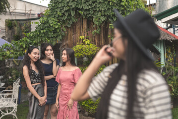 A woman notices three ladies apparently talking negatively or spreading malicious gossip about her....