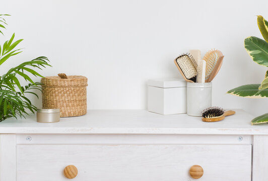 Hair Brushing And Make Up Items On Wooden Dressing Table