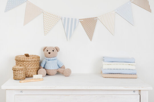Kids room decorated wall background and sideboard with baby goods