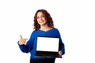 Naklejka premium Young girl smiling happy wearing blue pullover sweater isolated over white background holding laptop mockup of white blank screen. Pointing index finger on laptop pc computer with blank empty screen.