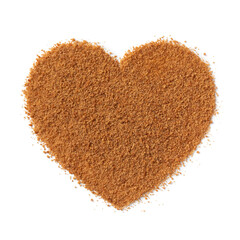 Golden palm sugar in heart shape isolated on white background close up