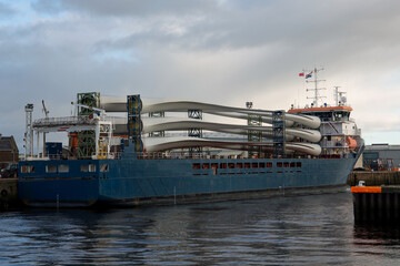 Wind Turbine Blade Sections on a Cargo Vessel at a Small Port