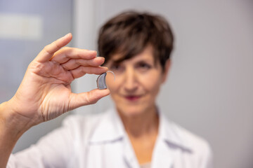 Two ent doctors demonstrating innovative hearing aids