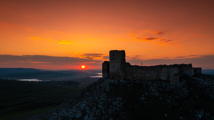 Sunset over Enisala Fortress and village. Aerial view with a beautiful sunset over this landmark place from Dobrogea, Romania.