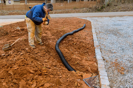 An Employee Digs Trench To Lay Drainage Pipe For Catch Rainwater During Heavy Rainfall