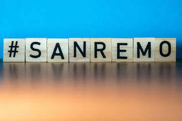Word Sanremo in wooden letters eith blue background. Italian music festival 2023. Sing concept.music concept. 