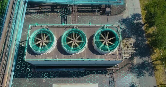 Cooling tower from a drone. Wet cooling towers. Industrial cooling towers with futuristic graphics. A futuristic shot of a factory exterior. Evaporative cooling towers