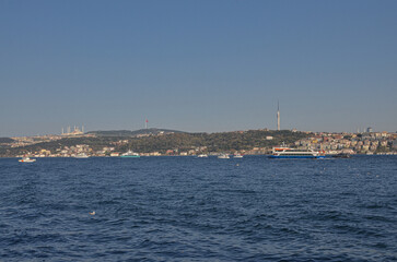 ferryboats on Bosporus strait and Anatolian side of Istanbul city view from Dolmabahce Palace pier