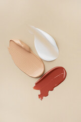 Smears of cosmetics on a beige background