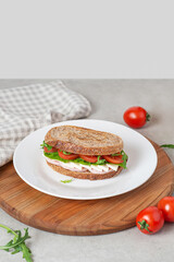 Sandwich with meat and cheese on a white plate
