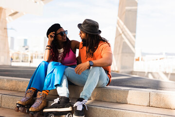 Cheerful couple with roller skating outside. Fun sexy boyfriend and girlfriend enjoy in sunny day