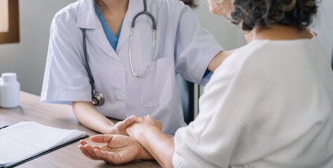 Female doctors shake hands with patients encouraging each other  To offer love, concern, and...