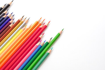 Top view of colored pencils or pastel on white background. Learning, study and presentation concept.