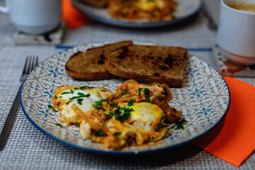 Breakfast, scrambled eggs with toast and coffee in a white cup