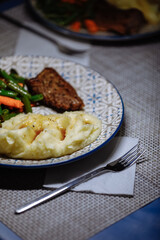Potatoes with meat and vegetables on the table