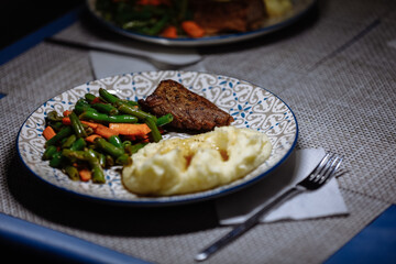 Potatoes with meat and vegetables on the table