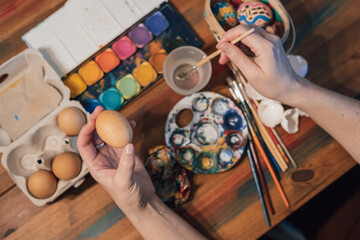 Hands painting easter eggs
