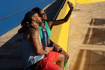 Cheerful couple with roller skating outside. Fun sexy boyfriend and girlfriend taking selfie photo