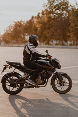 Fototapeta na wymiar rider on a black motorcycle with black helmet