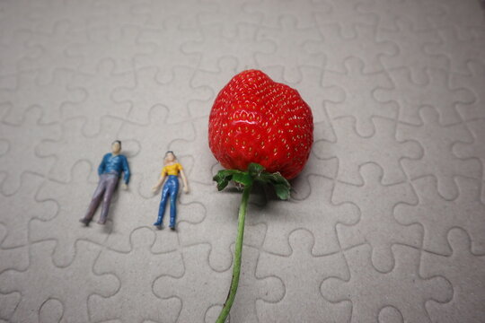 strawberry and people with puzzle background design for love and valentine concept