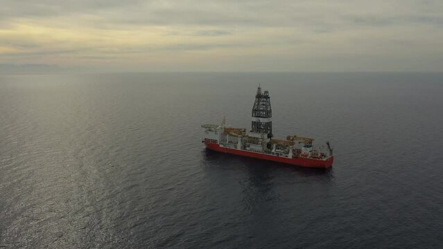 upper view drillship on calm ocean water under vast sky