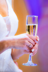 Aesthetic shot of woman in white clothes holding glass of wine