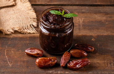 Useful and delicious date paste served in a glass jar. Homemade date cream paste.