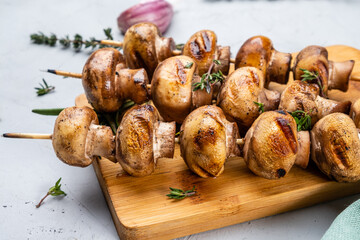 BBQ mushrooms grilled on wooden skewers. Close-up.