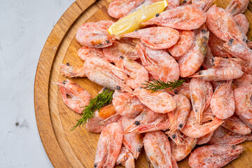 Shrimp frozen on a wooden board, gray background.