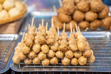 The Grilled meatballs with sauce Grilled meatballs are a popular snack at street food or night markets. Food and small business concept.