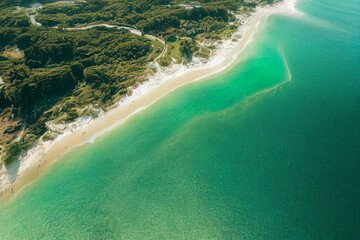 Fototapeta na wymiar Spectacular top view from drone photo of beautiful beach with relaxing sunlight, sea water waves pounding the sand at the shore. Calmness and refreshing beach scenery. Generative AI